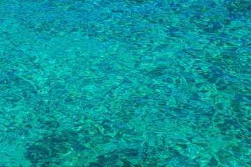 Fototapeta na wymiar background blurred turquoise, clear clear water in the Gulf of Fig Tree, in Protaras, Cyprus, in spring, in April