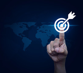 Businessman pressing target with dart icon over digital world map, Business success concept, Elements of this image furnished by NASA