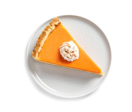 Plate with piece of fresh delicious homemade pumpkin pie on white background, top view