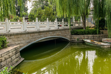 Fototapeta na wymiar A marble bridge on a small river in a traditional Beijing Hutong in China - 5