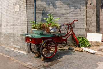 Fototapeta na wymiar Vintage bike in the narrow alley in a traditional Beijing Hutong in China - 2