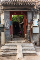 Fototapeta na wymiar A view of an entrance of a courtyard in a traditional Beijing Hutong in China - 4