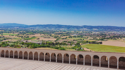 Corridor of lower square of St Francis in Assisi, Italy, with landscape in the distance