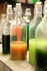 Various flavors of syrups in bottles at coffee shop