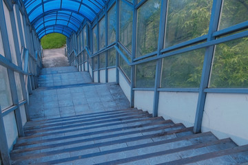 Stairs to elevated pedestrian crossing from the inside. Safe passage across the road.