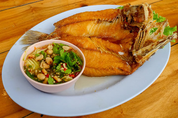 Snapper topped with sauce . 5