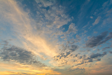 Naklejka na ściany i meble At sunset, the clouds are illuminated by the sun.