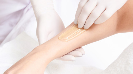 Unwanted hair wax epilation. Young Woman. cosmetology salon treatment procedure. Home waxing