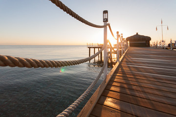 Obraz premium wooden pier sun-drenched, sunset or dawn