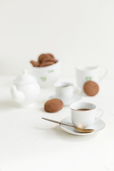 Breakfast on white table, tea and biscuits
