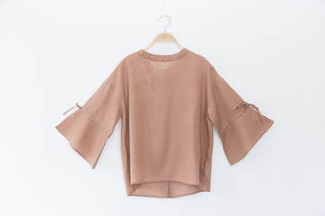 brown colour blouse on white background.minimal style