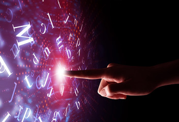 Female finger touching a beam of light surrounded by a pink background with alphabet letters