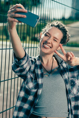 Happy lady showing her tongue while taking funny selfies