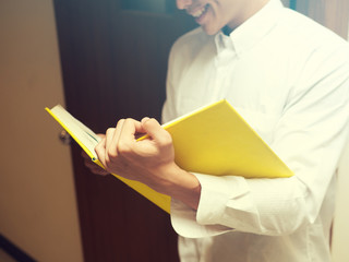 Asian university life concept. Young teenage student reading book in college library.