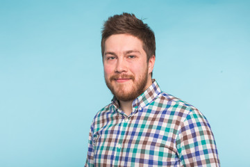 Fototapeta premium Close-up portrait of bearded handsome man on blue background
