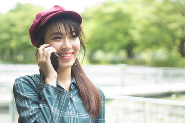 beautiful tourist woman has playing phone in the evening time at garden park
