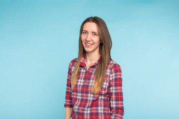 Fototapeta premium Portrait of young attractive caucasian woman in blue background