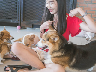 Portrait of Asian woman with dog.Gril playing with her dog in House.