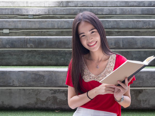 Young Asian female student with notebooks in her hands.A portrait of an Asian college student.education and learning concept.