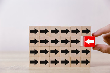 Hand picked red wooden blocks with white arrows facing opposite to the black arrows. With different...