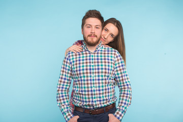 Portrait of cheerful funny young lovers on blue background