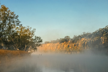 Fototapeta na wymiar Early morning mist and fog on the Murray River near Wakerie in South Australia.