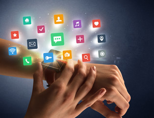 Naked female hand with smartwatch and  application labels around and dark background