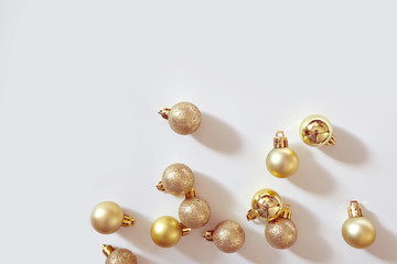 Colden Christmas balls on white background. New year backdrop.