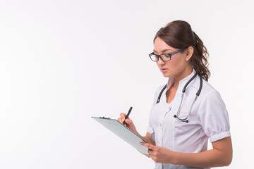 Female medicine doctor hand holding pen writing something on clipboard on white background with copy space - obrazy, fototapety, plakaty