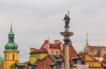 A view of the tops of houses in the old town of Warsaw, Poland, including Sigismund's Column,...