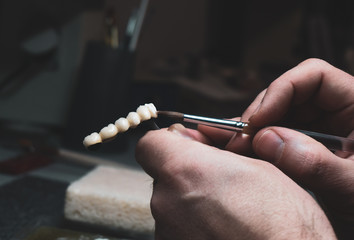 dental technician makes dental crowns. close-up.