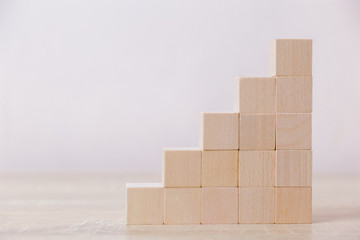 Arranging wood block stacking as step stair,With the concept of a thriving business going for success.