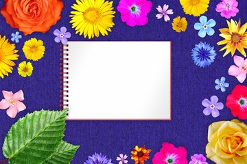 Beautiful flower frame with copybook in center on blue woolen cloth background. Floral composition of spring or summer flowers.