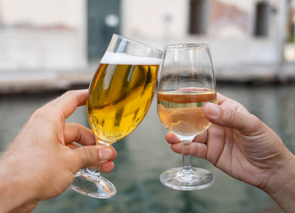Two glasses click toasting cheers of couple celebrating holidays