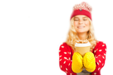 beautiful girl in Christmas clothes holding a cup of tea with Christmas cookies on an isolated background