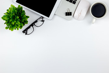 Top view of Office desk with workspace in office with blank notebook tablet and smartphone with other office supplies,with copy space.