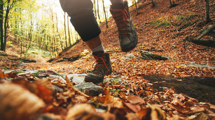 Close up of hiker legs running across the forest stream