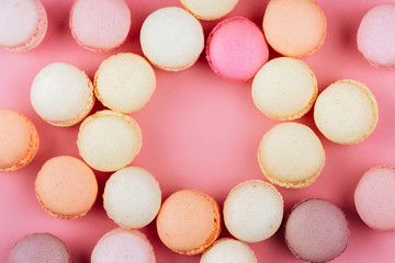 Sweet macaroons with vintage pastel colored tone on pink background.