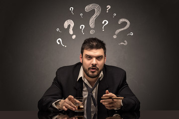 Young drunk disappointed man with question signs concept
