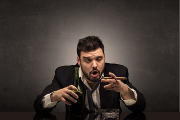 Young drunk man at his office with free dark copyspace