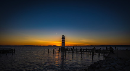 Beautiful colorful sunset over lake Neusiedler with Podersdorf lighthouse, Austria