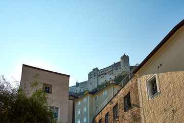 Castle on a hill above Salzburg, with old buildings and blue sky background