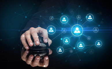 Hand using wireless mouse in a dark environment with human network concept