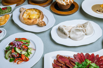 Georgian cuisine foodset from khachapuri, khinkali, pkhali, dolma, satsivi top view