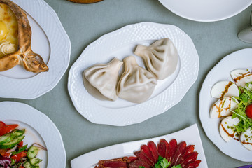 Georgian cuisine foodset from khachapuri, khinkali, pkhali, dolma, satsivi top view