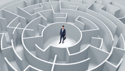 Young businessman standing in a middle of a 3d round maze
