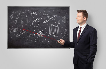 Handsome young teacher with laser pointer teaching 
