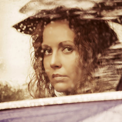 Sad woman looking out car window