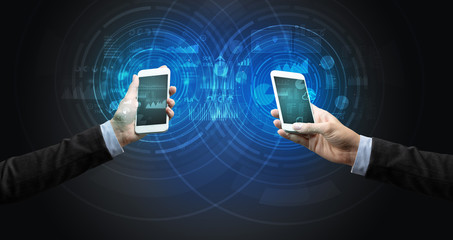 Close up of two smartphones syncing business data