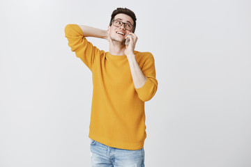 Handsome cute boyfriend being shy and hesitating scratching back of neck tilting head up as talking...